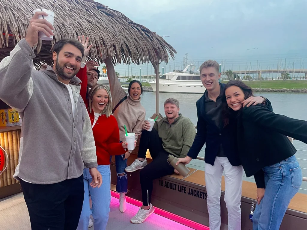 People had fun together, holding drinks in their hands, on a party boat of Gulf Coast Party Boats at Gulf Coast, Houston, Texas